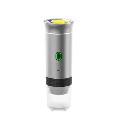 Silver portable espresso maker with green power button and transparent cup