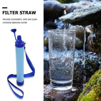 Portable filter straw for outdoor water purification beside glass with fresh stream