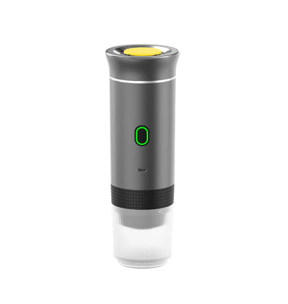 Portable espresso maker with black body, green power button, and clear bottom cup