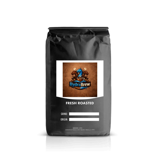 Black bag of fresh roasted coffee with label showing HydraBrew logo, grind and origin fields